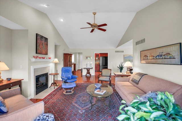 1906 Lydia Ct Unit A, Urbana, IL 61802 - living room with wood finished floors, a ceiling fan, high vaulted ceiling, a tile fireplace, and recessed lighting
