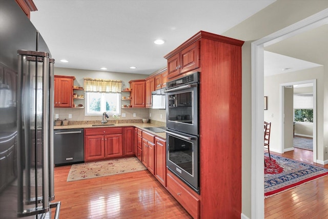 1906 Lydia Ct Unit A, Urbana, IL 61802 - kitchen with appliances with stainless steel finishes, open shelves, light wood-style flooring, tasteful backsplash, and recessed lighting
