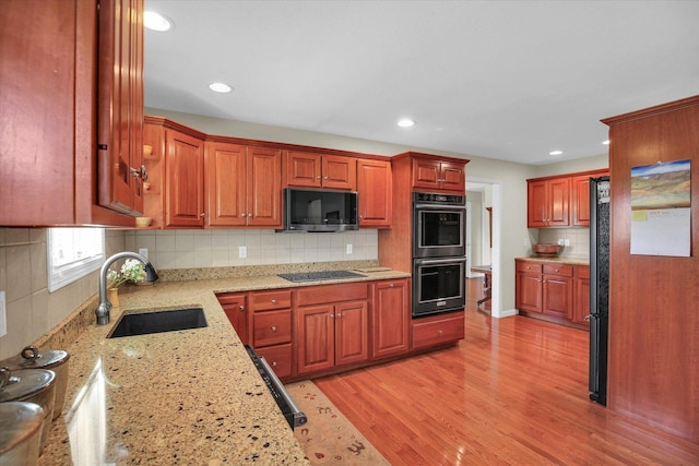 1906 Lydia Ct Unit A, Urbana, IL 61802 - kitchen with black appliances, backsplash, light stone countertops, light wood-type flooring, and recessed lighting