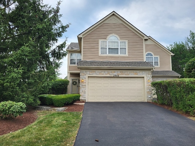 2949 Brossman St, Naperville, IL 60564 - view of front of house with an attached garage, driveway, stone siding, and a shingled roof