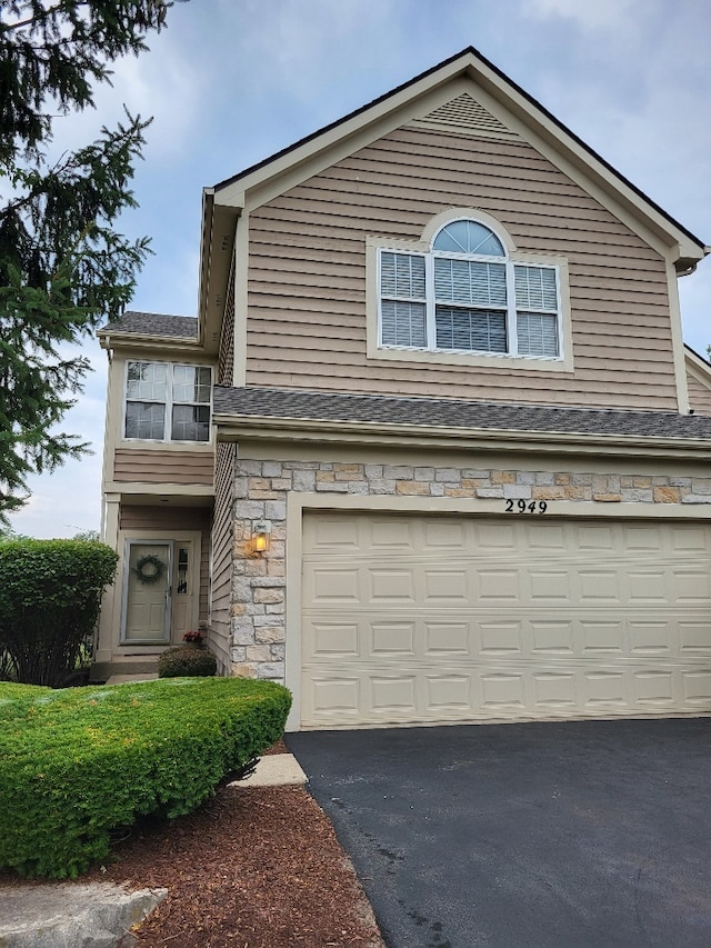 2949 Brossman St, Naperville, IL 60564 - view of front of property with an attached garage, asphalt driveway, stone siding, and a shingled roof