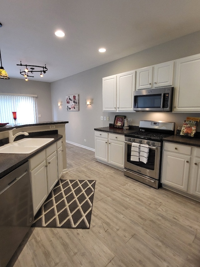 2949 Brossman St, Naperville, IL 60564 - kitchen with appliances with stainless steel finishes, dark countertops, white cabinets, light wood-style flooring, and recessed lighting