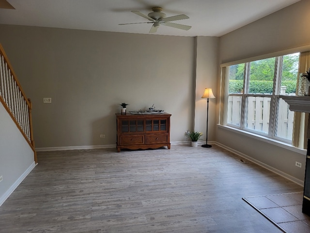 2949 Brossman St, Naperville, IL 60564 - spare room with wood finished floors, a ceiling fan, and stairs