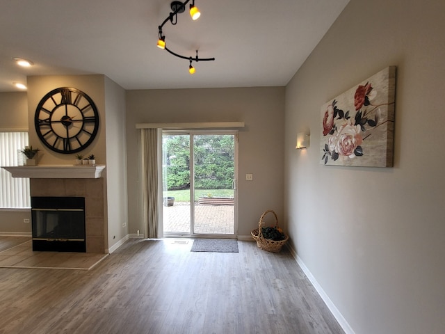 2949 Brossman St, Naperville, IL 60564 - unfurnished living room featuring wood finished floors, a tile fireplace, and track lighting