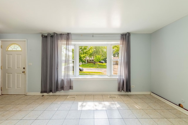 100 Patricia Dr, Schaumburg, IL 60193 - entrance foyer with light tile patterned floors and baseboards