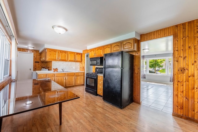 100 Patricia Dr, Schaumburg, IL 60193 - kitchen with black appliances, light countertops, backsplash, light wood finished floors, and brown cabinetry