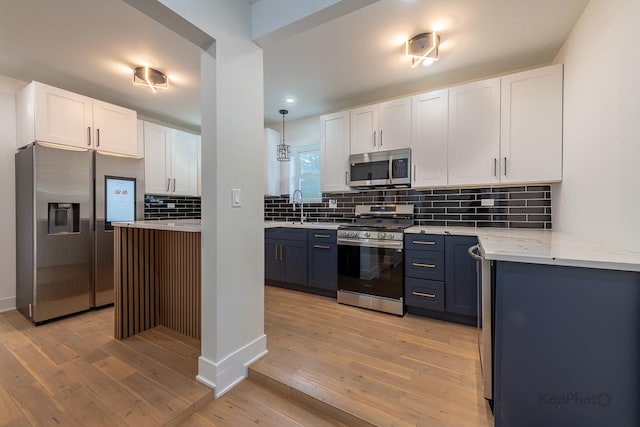 11956 S Harvard Ave, Chicago, IL 60628 - kitchen featuring stainless steel appliances, white cabinetry, light wood-type flooring, tasteful backsplash, and recessed lighting