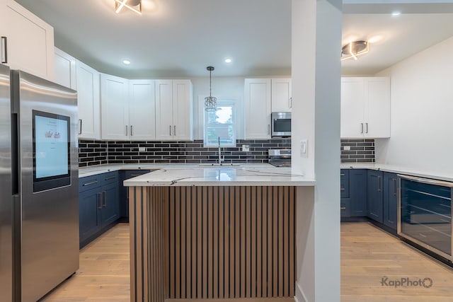 11956 S Harvard Ave, Chicago, IL 60628 - kitchen featuring appliances with stainless steel finishes, wine cooler, light wood finished floors, white cabinets, and blue cabinets