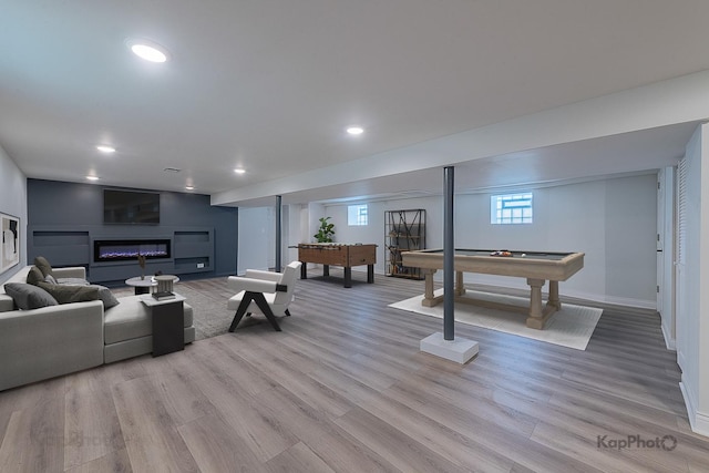 11956 S Harvard Ave, Chicago, IL 60628 - living room featuring billiards table, light wood-type flooring, a glass covered fireplace, and recessed lighting