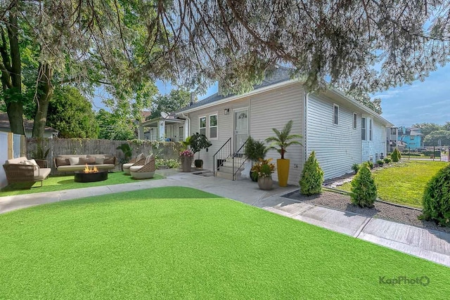 11956 S Harvard Ave, Chicago, IL 60628 - view of front of house with entry steps, a patio area, and an outdoor living space with a fire pit
