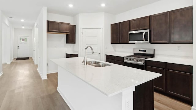 2275 Redwood Trl, Wonder Lake, IL 60097 - kitchen featuring stainless steel appliances, a kitchen island with sink, dark brown cabinets, light wood-type flooring, and recessed lighting