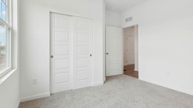 2275 Redwood Trl, Wonder Lake, IL 60097 - unfurnished bedroom with carpet, a closet, and multiple windows