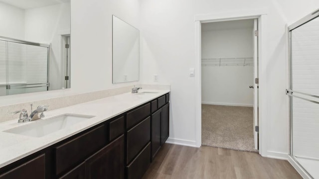 2275 Redwood Trl, Wonder Lake, IL 60097 - full bath with wood finished floors, a stall shower, double vanity, and a spacious closet