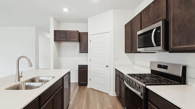 2275 Redwood Trl, Wonder Lake, IL 60097 - kitchen with stainless steel appliances, light wood finished floors, light countertops, dark brown cabinetry, and recessed lighting