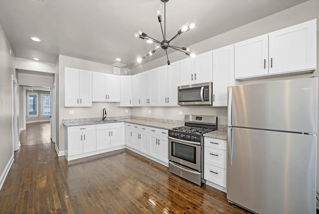 1652 S Ridgeway Ave, Chicago, IL 60623 - kitchen featuring appliances with stainless steel finishes, a chandelier, dark wood-style flooring, recessed lighting, and white cabinets