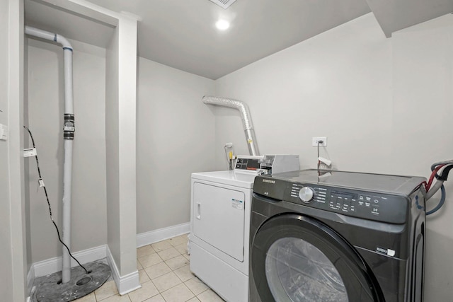 1652 S Ridgeway Ave, Chicago, IL 60623 - washroom featuring washing machine and dryer and light tile patterned flooring