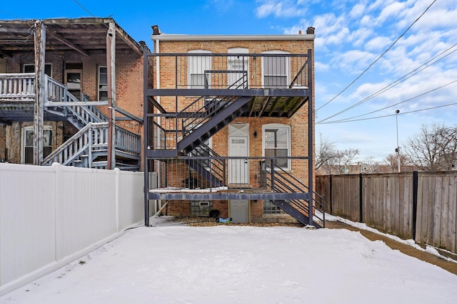 1652 S Ridgeway Ave, Chicago, IL 60623 - view of front of house with stairs, brick siding, and a fenced backyard