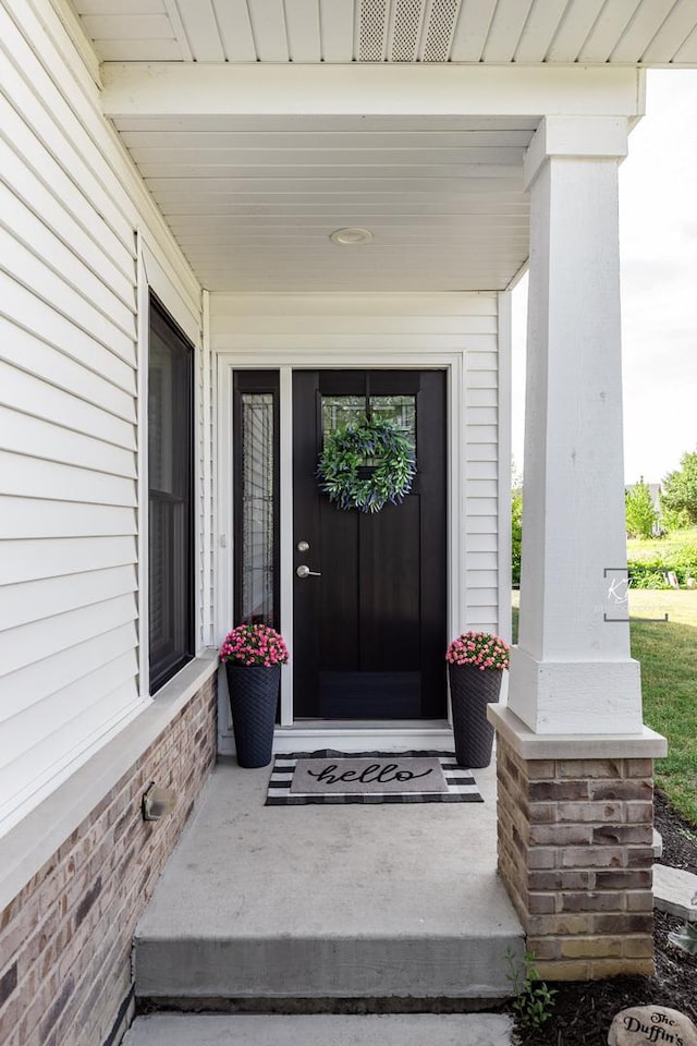 561 Sudbury Cir, Oswego, IL 60543 - property entrance featuring covered porch