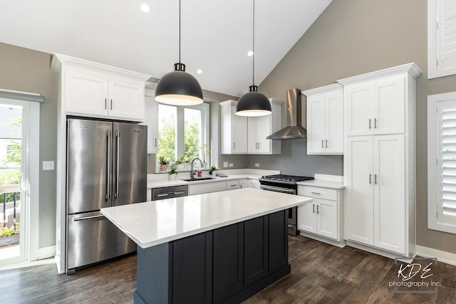 561 Sudbury Cir, Oswego, IL 60543 - kitchen with appliances with stainless steel finishes, wall chimney exhaust hood, dark wood-style floors, light countertops, and recessed lighting