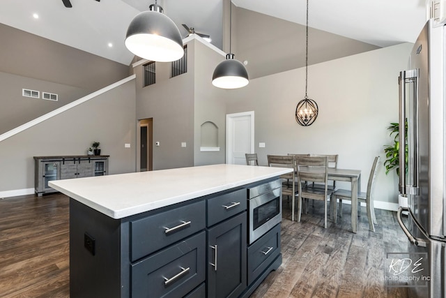 561 Sudbury Cir, Oswego, IL 60543 - kitchen with high vaulted ceiling, appliances with stainless steel finishes, dark wood-type flooring, a kitchen island, and light countertops