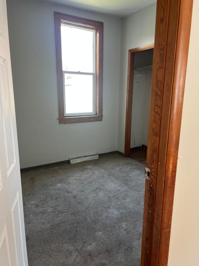320 W Saint Paul St, Spring Valley, IL 61362 - unfurnished bedroom with carpet flooring, baseboard heating, and a closet
