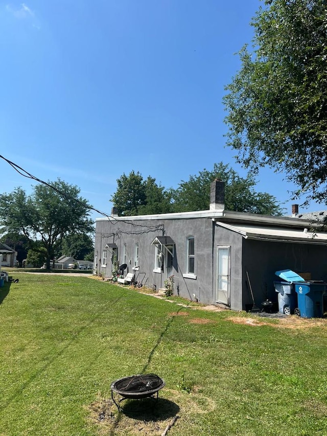 320 W Saint Paul St, Spring Valley, IL 61362 - back of property featuring a fire pit, a yard, and stucco siding