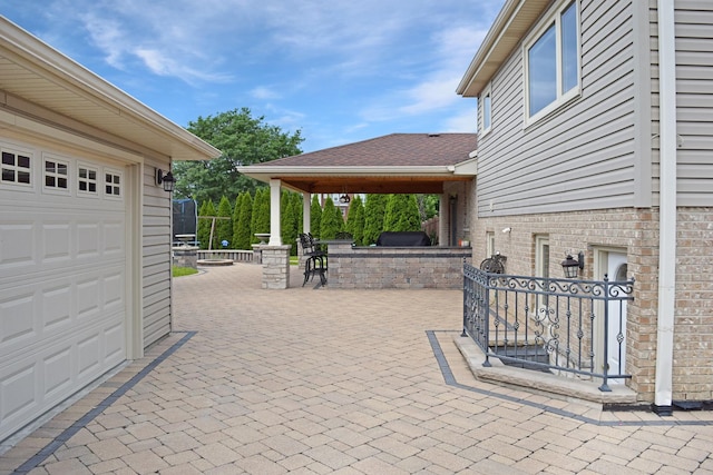 9343 170th Pl, Orland Hills, IL 60487 - view of patio featuring an outdoor kitchen, a garage, and exterior bar