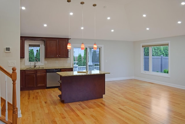 9343 170th Pl, Orland Hills, IL 60487 - kitchen featuring stainless steel dishwasher, light wood-style floors, tasteful backsplash, a kitchen island, and pendant lighting
