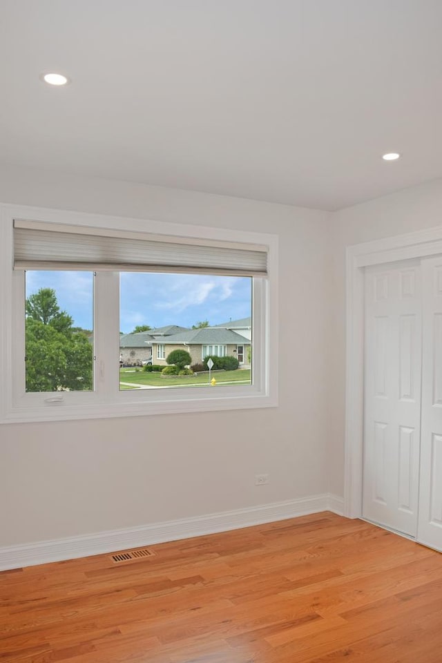 9343 170th Pl, Orland Hills, IL 60487 - unfurnished bedroom featuring multiple windows, light wood-style flooring, a closet, and recessed lighting