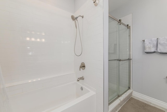 2409 W Catalpa Ave Unit 307, Chicago, IL 60625 - bathroom featuring baseboards and shower / bath combination with glass door