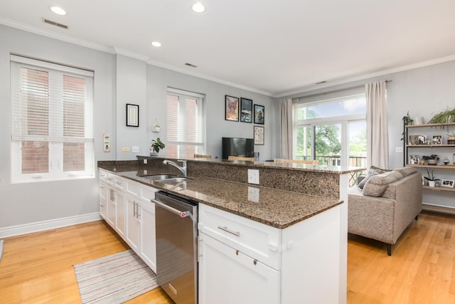 2409 W Catalpa Ave Unit 307, Chicago, IL 60625 - kitchen with stainless steel dishwasher, a peninsula, light wood-style floors, open floor plan, and ornamental molding