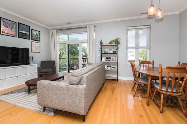 2409 W Catalpa Ave Unit 307, Chicago, IL 60625 - living room featuring light wood finished floors, healthy amount of natural light, and ornamental molding