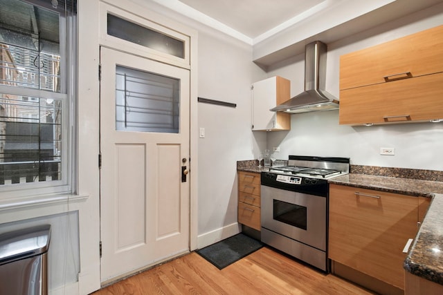 542 W Brompton Ave Unit 1S, Chicago, IL 60657 - kitchen with gas stove, wall chimney exhaust hood, light wood-style floors, and dark stone countertops