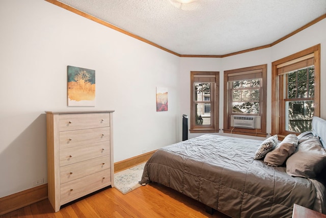 542 W Brompton Ave Unit 1S, Chicago, IL 60657 - bedroom with cooling unit, light wood-type flooring, ornamental molding, and a textured ceiling