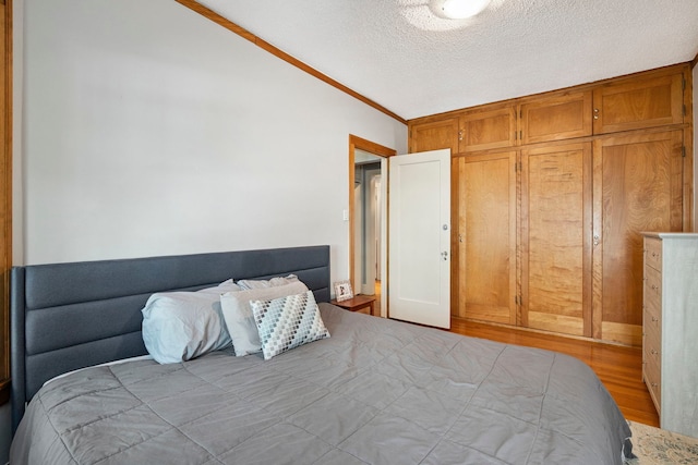 542 W Brompton Ave Unit 1S, Chicago, IL 60657 - bedroom featuring wood finished floors, a textured ceiling, and crown molding
