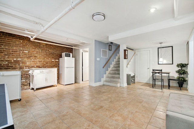 542 W Brompton Ave Unit 1S, Chicago, IL 60657 - living area with stairs, brick wall, and light tile patterned flooring