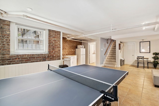 542 W Brompton Ave Unit 1S, Chicago, IL 60657 - game room with light tile patterned flooring and brick wall