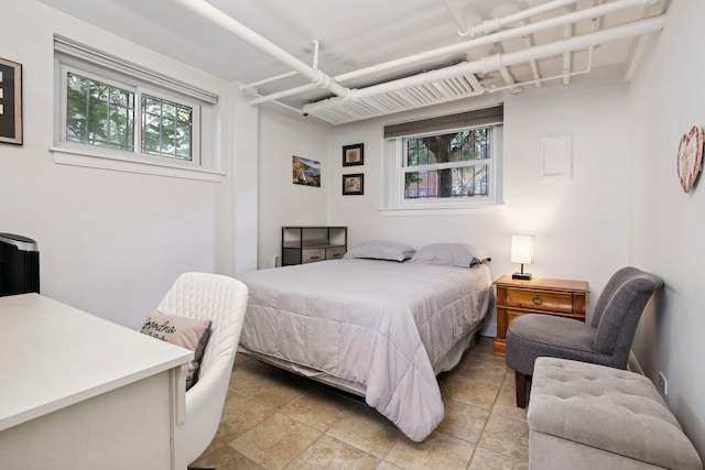 542 W Brompton Ave Unit 1S, Chicago, IL 60657 - bedroom featuring multiple windows and light stone finish floors