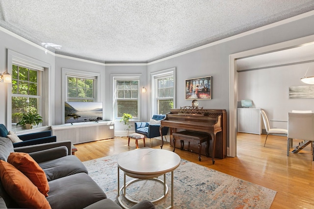 542 W Brompton Ave Unit 1S, Chicago, IL 60657 - living area featuring crown molding, plenty of natural light, a textured ceiling, wood finished floors, and radiator heating unit