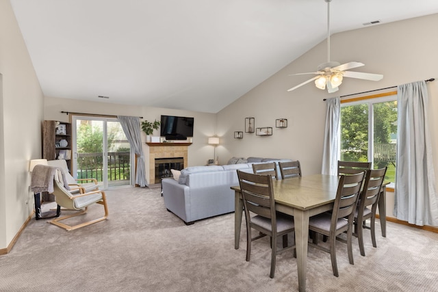 2408 Danbury Dr Unit A2, Woodridge, IL 60517 - dining space featuring vaulted ceiling, ceiling fan, a tiled fireplace, and light colored carpet