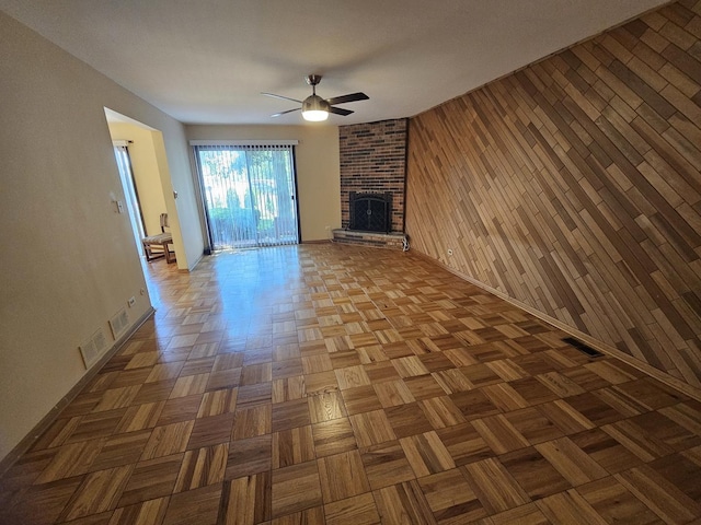 7215 Beckwith Rd, Morton Grove, IL 60053 - unfurnished living room with a ceiling fan, wooden walls, and a brick fireplace
