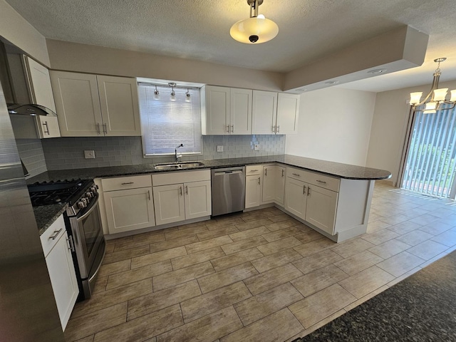 7215 Beckwith Rd, Morton Grove, IL 60053 - kitchen featuring appliances with stainless steel finishes, a peninsula, decorative backsplash, a chandelier, and white cabinetry