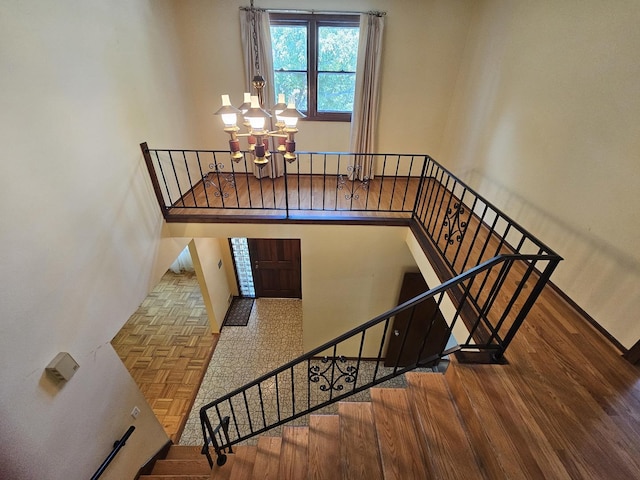 7215 Beckwith Rd, Morton Grove, IL 60053 - staircase featuring a chandelier and parquet floors