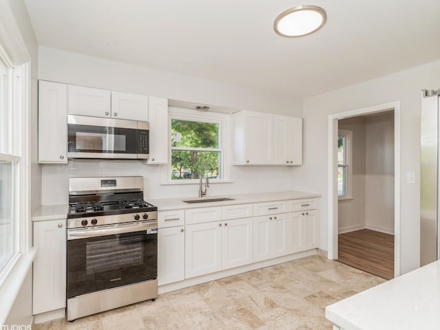 2402 Marshall Pkwy, Waukegan, IL 60085 - kitchen featuring appliances with stainless steel finishes, light countertops, and white cabinets