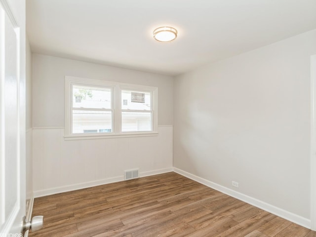 2402 Marshall Pkwy, Waukegan, IL 60085 - unfurnished room with a wainscoted wall and wood finished floors
