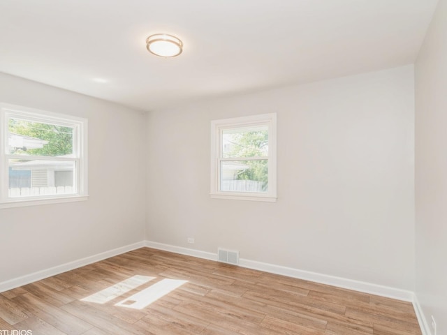 2402 Marshall Pkwy, Waukegan, IL 60085 - unfurnished room with healthy amount of natural light and light wood-style floors