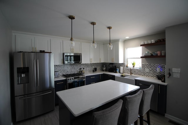 6142 W 60th St, Chicago, IL 60638 - kitchen with stainless steel appliances, white cabinets, tasteful backsplash, a kitchen island, and recessed lighting