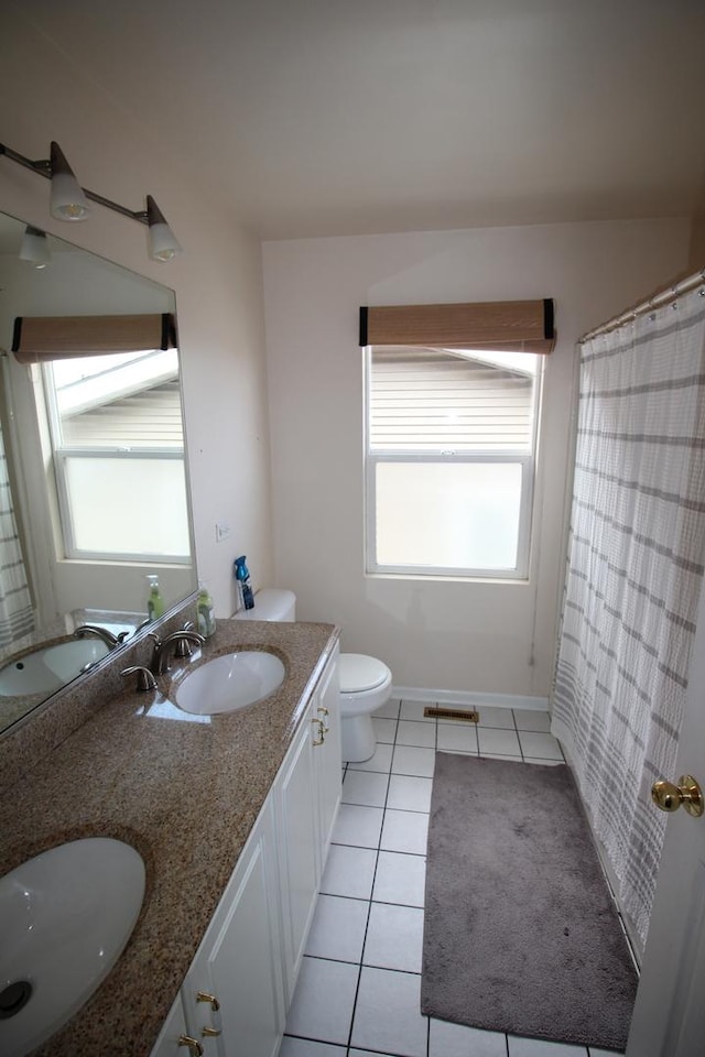 6142 W 60th St, Chicago, IL 60638 - bathroom featuring double vanity, tile patterned floors, and healthy amount of natural light