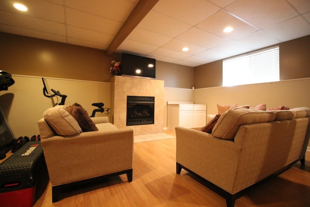6142 W 60th St, Chicago, IL 60638 - living area with wood finished floors, a drop ceiling, a tiled fireplace, and recessed lighting