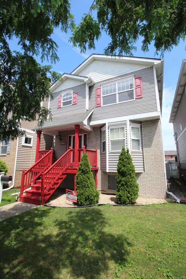 6142 W 60th St, Chicago, IL 60638 - view of front of home featuring brick siding, a front lawn, and stairway